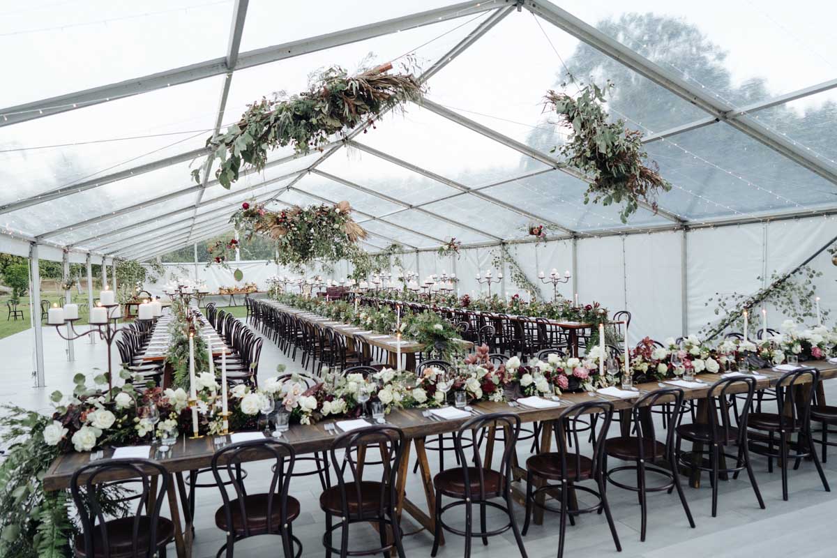 Clear marquee with hanging floral and extensive table decoration